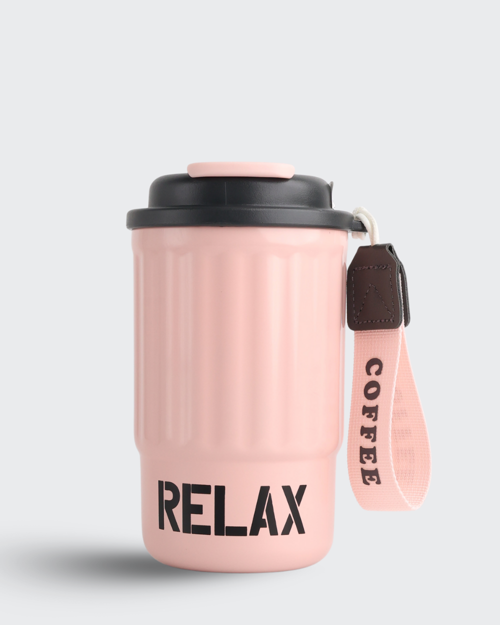 Pink coffee tumbler with 'RELAX' text and 'COFFEE' strap on a light gray background