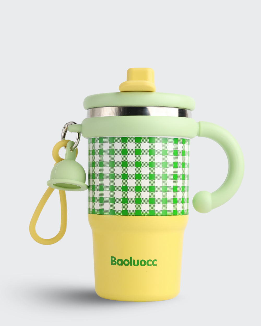 Children's sippy cup with green checkered sleeve and yellow base on a light gray background