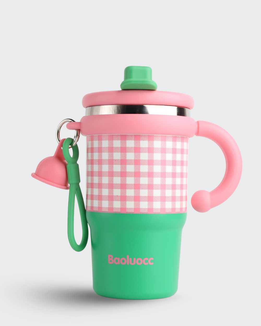 Children's sippy cup with pink and green design on a light gray background