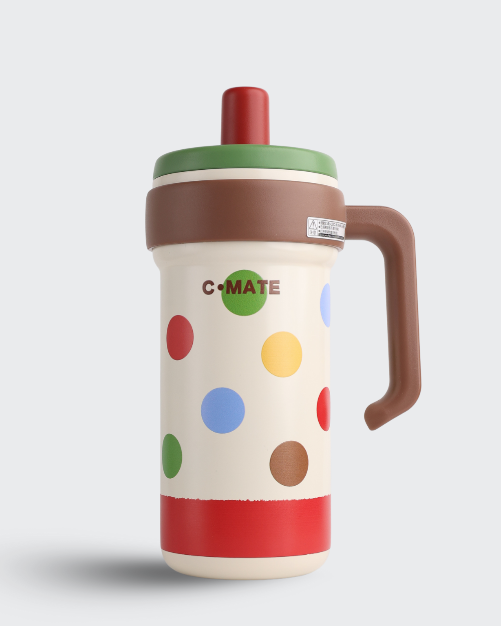 Colorful polka dot mug with a handle on a light gray background