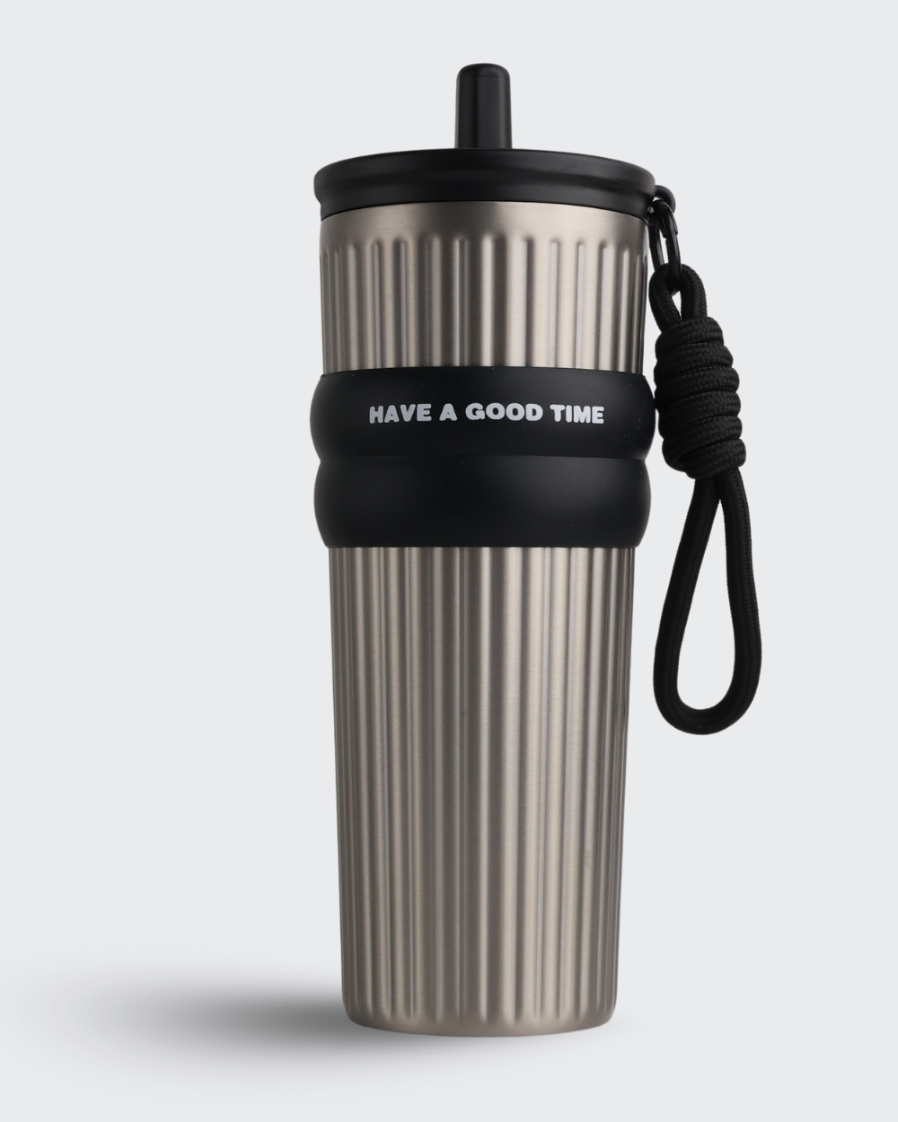 Metallic travel mug with black lid and strap on a light gray background