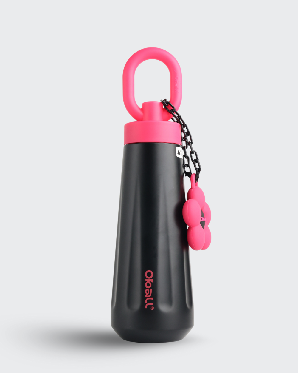 Black and pink dog water bottle with a keychain on a light gray background