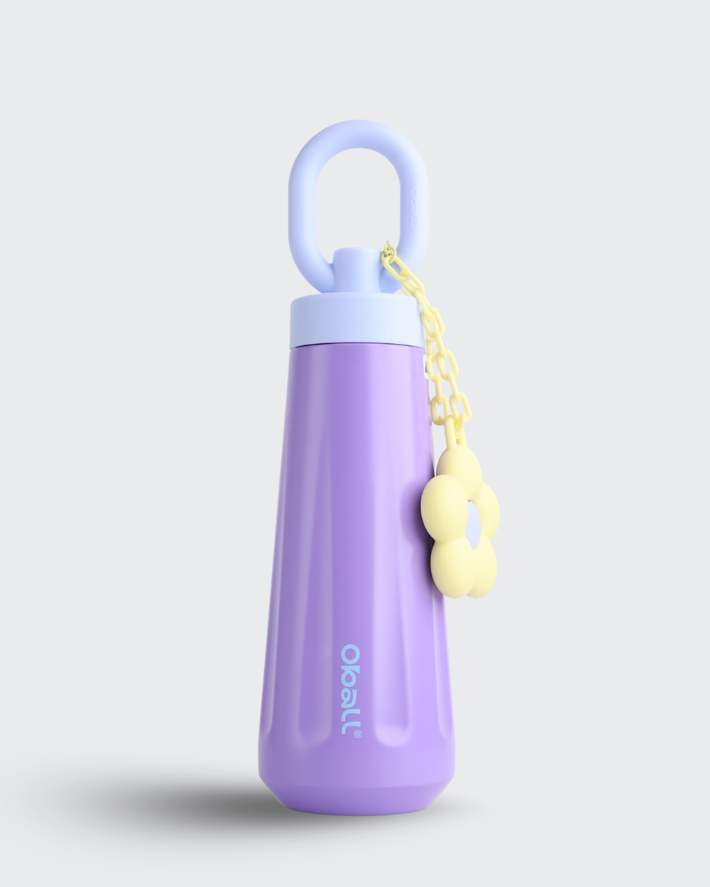 Purple water bottle with a yellow keychain on a light gray background